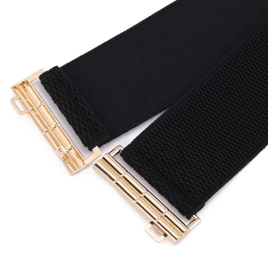 Elastic black waist belt for women with elegant golden metal buckle and bamboo texture