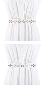 Détail des chaînes de taille en métal doré et argenté avec motif fleur ajouré