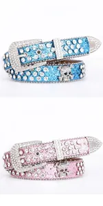 Detailed view of Y2K rhinestone belts in sky blue and pink with skull metal ornaments