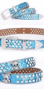 Detailed macro view of punk style blue rhinestone belt with skull buckles and metal studs