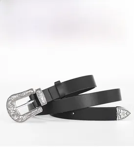 Détail de la ceinture en cuir noir avec 12 œillets et boucle argentée avec gravures