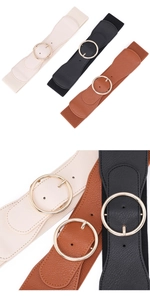 Detailed view of elastic wide belts in white black and brown with golden round buckles