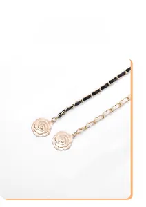 Close-up of gold chain belt with PU leather and detailed camellia flower charms