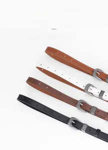 Detail of vintage carved zinc alloy buckles on slim belts in four colors