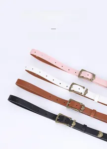 Detail view of four colored slim belts with vintage engraved zinc alloy buckles in a row