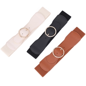 Three wide elastic waist belts in cream, black, and tan with gold round metal buckles