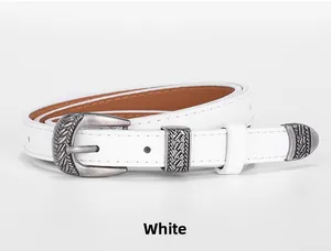 Detail of white belt with vintage silver buckle and engraved woven texture detail