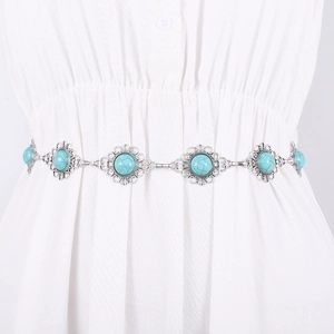 Vintage silver metal waist chain belt with turquoise relief pattern on white dress