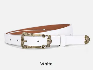 Detailed view of white vintage belt with ornate bronze buckle and engraved metal tip