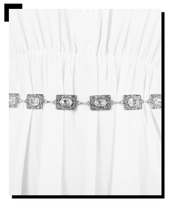 Detailed macro of vintage silver belt chain with crystal inlays on white dress