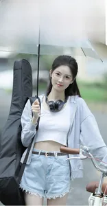 Close-up of casual grey zip-up hoodie paired with a white crop top and denim shorts