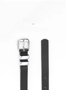 Detail of minimalist black slim belt featuring a polished silver double-ring alloy buckle