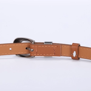 Vintage brown leather belt with retro engraved silver buckle and classic pin closure