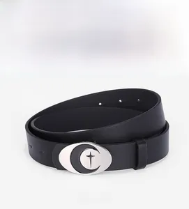 Close-up of vintage silver oval buckle with crescent moon and star on black leather belt