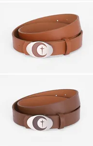 Close-up of brown and dark brown leather belts with oval silver moon and star buckles