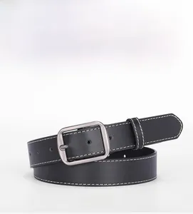 Close-up of black leather belt with white stitching and matte silver square buckle