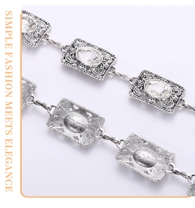Detailed macro view of vintage silver metal waist chain with rhinestone inlays