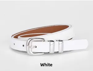 Macro shot of white leather belt detail with double silver metal loop and polished buckle