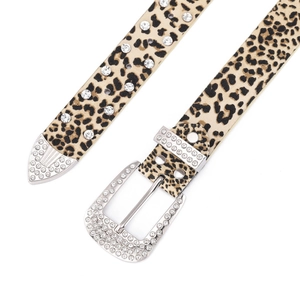 Macro detail of leopard print belt with crystal-encrusted buckle and western rivets