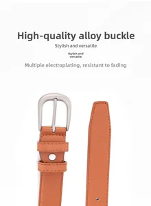 Close-up of brown leather belt showing matte silver alloy buckle and fine stitching details
