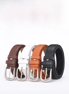 Detailed view of four leather belts in brown, white, and black with matte silver buckles