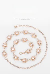 Detailed close-up of gold metal waist chain featuring plum blossom motifs and pearls