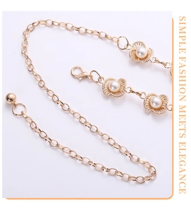 Detail of gold metal belt with pearl plum blossom accents and secure lobster clasp