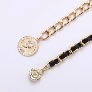 Elegant gold metal chain belt with black leather weave and vintage coin pendant