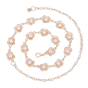 Elegant gold metal waist chain featuring plum blossom links with pearls on a white background