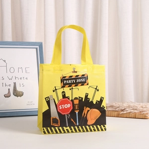Yellow non-woven construction theme gift bag with Party Zone print and tool patterns