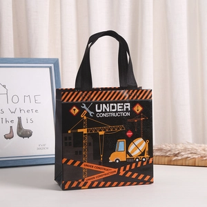 Black non-woven gift bag with colorful construction crane print and reinforced handles