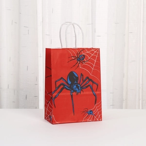 Macro detail of red paper gift bag featuring a spider web print and white rope handle