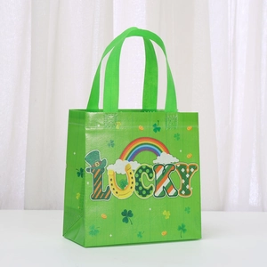 Detail of St. Patrick's Day green non-woven gift bag with Lucky rainbow and clover prints