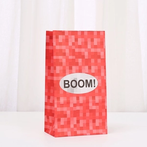 Detail of red pixelated paper gift bag with TNT style and BOOM label for party favors