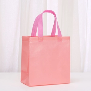 Pink macaron non-woven tote bag with textured surface and reinforced handles