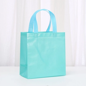 Cyan waterproof non-woven tote bag with reinforced handles for shopping and gift packaging