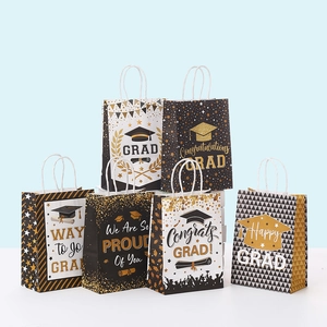 Detail view of graduation paper gift bags featuring black and gold celebratory patterns
