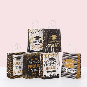 Detail of graduation gift bags with reinforced handles and festive gold foil patterns