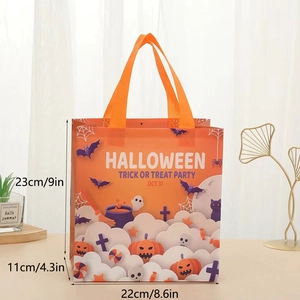 Detail view of Halloween non-woven gift bag with pumpkin prints and sturdy orange handles