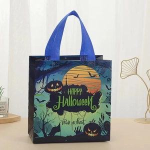 Close-up of Halloween non-woven gift bag featuring pumpkin and bat prints on dark blue