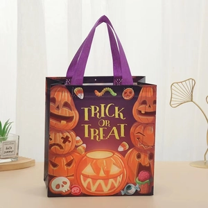 Detail of Halloween non-woven gift bag with pumpkin prints and purple handles