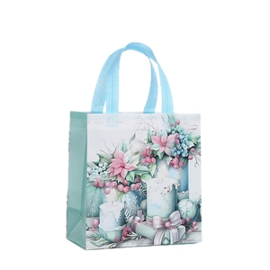 Christmas non-woven gift bag with watercolor candle and flower prints for holiday shopping