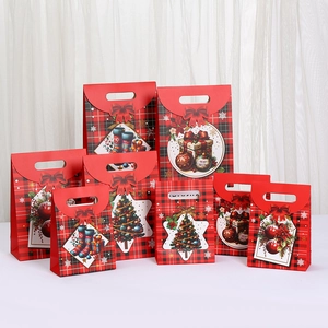 Red plaid Christmas gift bags with festive illustrations and ribbon handles in various sizes