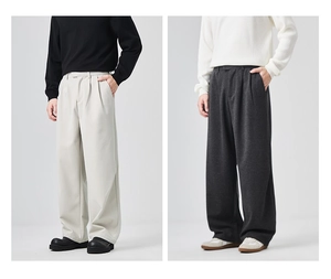 Detail view of loose-fitting men's casual trousers in off-white and dark grey colors