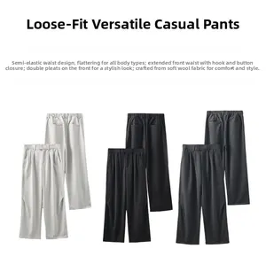 Detail view of the half-elastic waist and double-pleat design on soft wool trousers