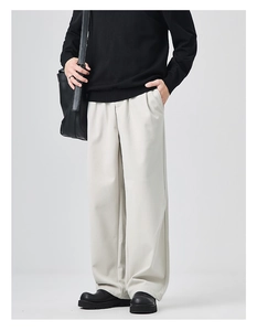 Detail view of men's wide-leg wool trousers in light grey with premium drape and side pockets