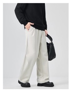 Minimalist men's loose straight trousers in light beige with elegant drape and pleat detail