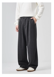 Detail view showing thick drape and soft texture of grey wide-leg trousers for men