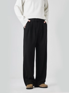 Men's relaxed fit straight leg black trousers featuring front pleats and heavy drape