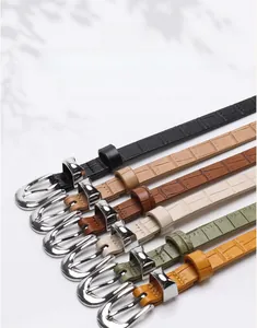Detail of six chic faux leather belts with stone texture and silver alloy buckles